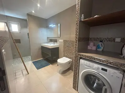 a bathroom with a washer and a washing machine at Vacances Bonifacio Bergerie in Bonifacio