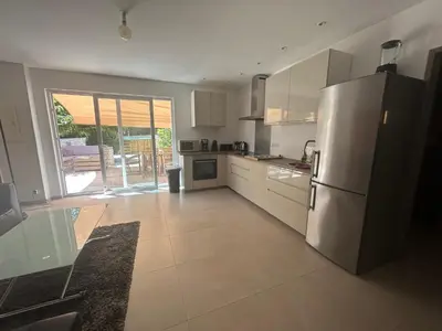 a kitchen with a stainless steel refrigerator and a patio at Vacances Bonifacio Bergerie in Bonifacio