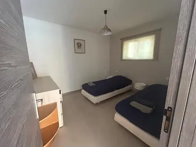 a bedroom with two beds and a window at Vacances Bonifacio Bergerie in Bonifacio