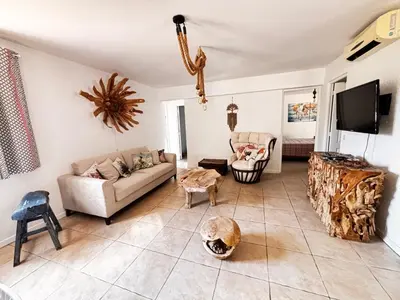 a living room with a couch and a tv at La Villa Maquis in Bonifacio