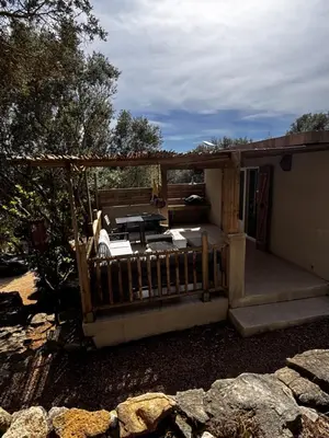 a porch of a house with a fence at La Villa Maquis in Bonifacio