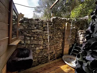 a stone wall with aburningificialificialificialificialificialificialificialificialificialificial at La Villa Maquis in Bonifacio