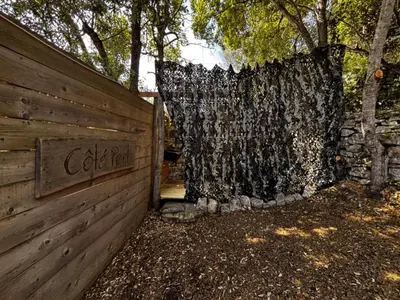 a wooden fence with a sign that says cedar room at La Villa Maquis in Bonifacio