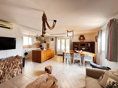 a living room with a couch and a table at La Villa Maquis in Bonifacio