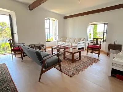 a living room with a couch and chairs at L'appartement Montecristo in Aléria