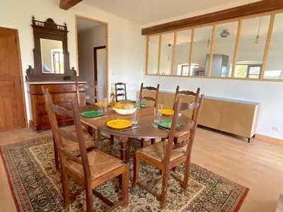 a dining room with a wooden table and chairs at L'appartement Montecristo in Aléria