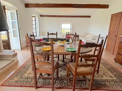 a dining room with a wooden table and chairs at L'appartement Montecristo in Aléria