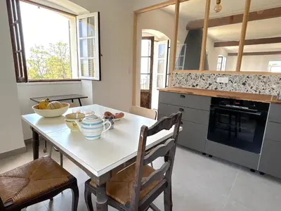 a kitchen with a table with a bowl of fruit on it at L'appartement Montecristo in Aléria