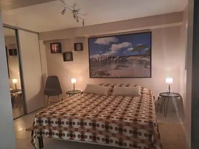 a bedroom with a bed and a painting on the wall at Le Maquis in Alata