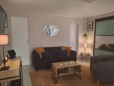 a living room with a couch and a table at Le Maquis in Alata