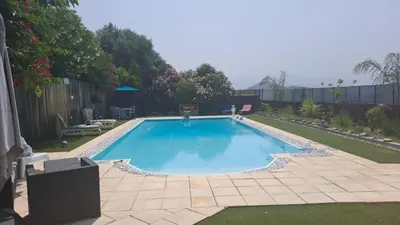 a large swimming pool in a yard at Le Maquis in Alata
