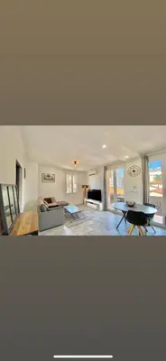 a living room with a couch and a table at Appartement Ajaccio private parking in Ajaccio