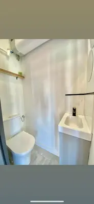 a bathroom with a white toilet and a sink at Appartement Ajaccio private parking in Ajaccio