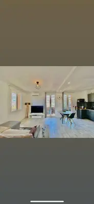 a large room with a bed and a table at Appartement Ajaccio private parking in Ajaccio