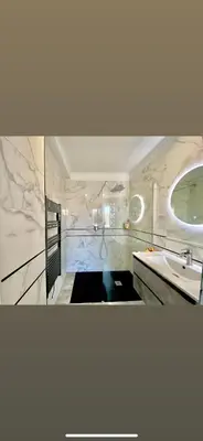 a bathroom with a sink and a mirror at Appartement Ajaccio private parking in Ajaccio