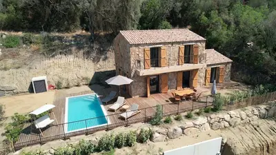 a small house with a swimming pool in front of it at Bergerie avec piscine chauffée Sotta in Sotta