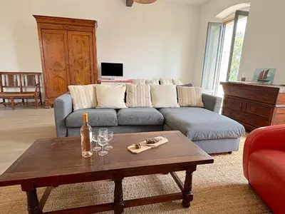 a living room with a couch and a table with wine glasses at L'appartement Pianosa in Aléria