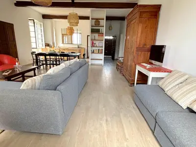a living room with two couches and a dining room at L'appartement Pianosa in Aléria