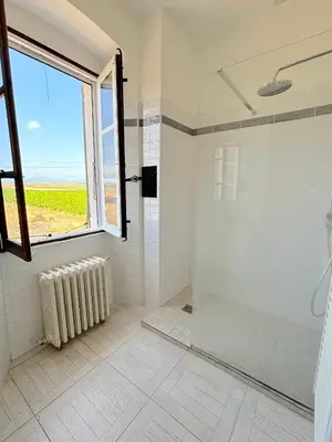 a bathroom with a shower and a window at L'appartement Pianosa in Aléria