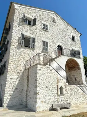 a building with a staircase on the side of it at L'appartement Pianosa in Aléria