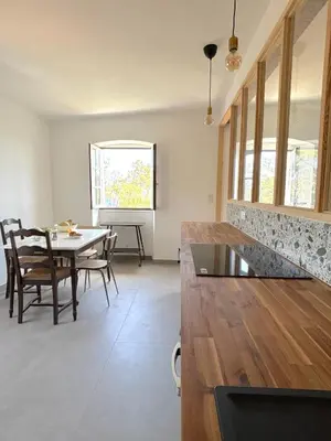 a kitchen and dining room with a table and chairs at L'appartement Montenosa in Aléria