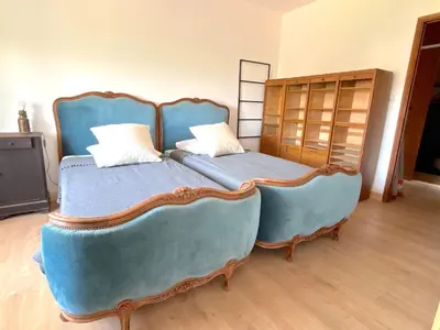 a bedroom with a blue bed with two pillows at L'appartement Montenosa in Aléria