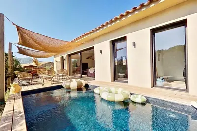 a house with a swimming pool with a villa at La Villa Geneviève, Maison 6 personnes avec piscine in Calenzana