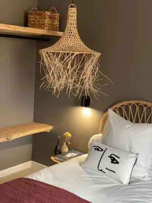 a bedroom with a bed and a chandelier at La Villa Geneviève, Maison 6 personnes avec piscine in Calenzana