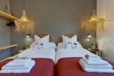 two beds with faces drawn on them in a bedroom at La Villa Geneviève, Maison 6 personnes avec piscine in Calenzana