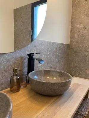 a bathroom sink with a stone vessel sink at La Villa Geneviève, Maison 6 personnes avec piscine in Calenzana