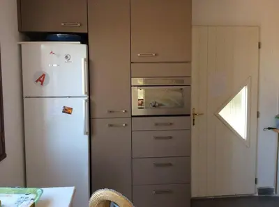 a kitchen with a white refrigerator and an oven at Casa di Purgu in Sotta