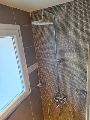 a shower with a shower head in a bathroom at Casa di Purgu in Sotta