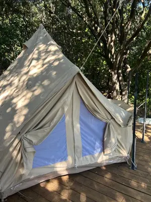 a white tent sitting on a wooden deck at Tente Lodge avec Vue sur la Baie d'Ajaccio in Ajaccio
