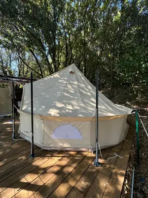a large white tent on a wooden deck at Tente Lodge avec Vue sur la Baie d'Ajaccio in Ajaccio