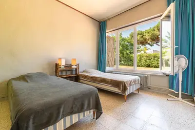 a bedroom with a bed and a window at Parad'Isula - Avec piscine à Porticcio in Grosseto-Prugna