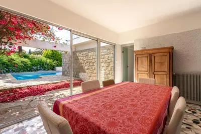a dining room with a red table and chairs at Parad'Isula - Avec piscine à Porticcio in Grosseto-Prugna