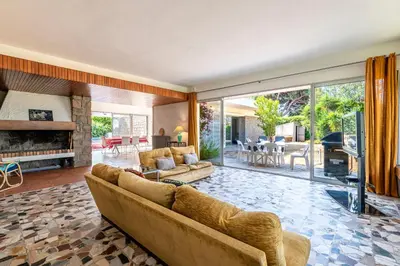 a living room with a couch and a fireplace at Parad'Isula - Avec piscine à Porticcio in Grosseto-Prugna