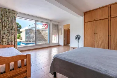 a bedroom with a bed and a large window at Parad'Isula - Avec piscine à Porticcio in Grosseto-Prugna