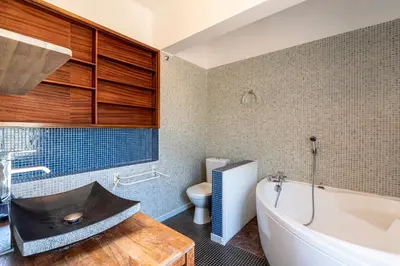 a bathroom with a tub and a sink and a toilet at Parad'Isula - Avec piscine à Porticcio in Grosseto-Prugna