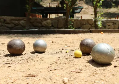 a group of balls sitting on a dirt field at Alivi Di A Restonica in Corte