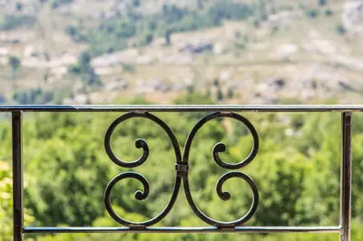 a metal railing with a view of a mountain at A Sant'Anna in Albertacce