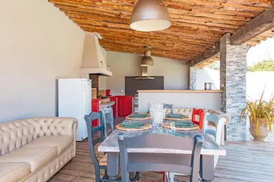 a kitchen and dining room with a table and chairs at Villa Lisa Porto-Vecchio in Porto-Vecchio