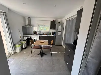 a small kitchen with a table and chairs in it at villa Morgane in Calenzana
