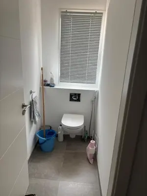 a small bathroom with a toilet and a window at villa Morgane in Calenzana