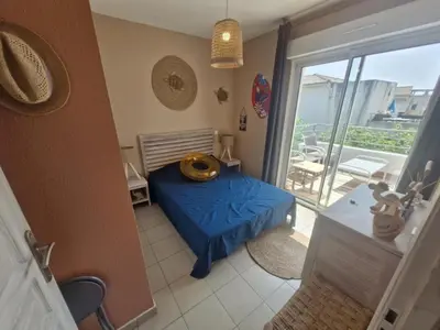 a bedroom with a blue bed and a balcony at Casa Verde Poggio Mezzana in Poggio-Mezzana