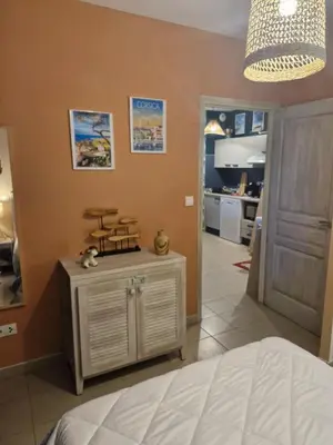 a bedroom with a bed and a room with a kitchen at Casa Verde Poggio Mezzana in Poggio-Mezzana
