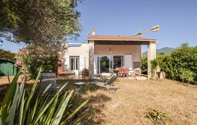 a small white house with chairs in the yard at 2 Bedroom Gorgeous Home In Prunete in Prunete
