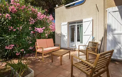 a patio with chairs and a table and flowers at 2 Bedroom Gorgeous Home In Prunete in Prunete