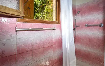 a pink tiled shower with a window in a bathroom at Cozy Apartment In Piana in Piana