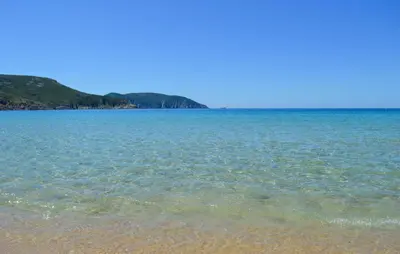 a large body of water with a sandy beach at Cozy Apartment In Piana in Piana